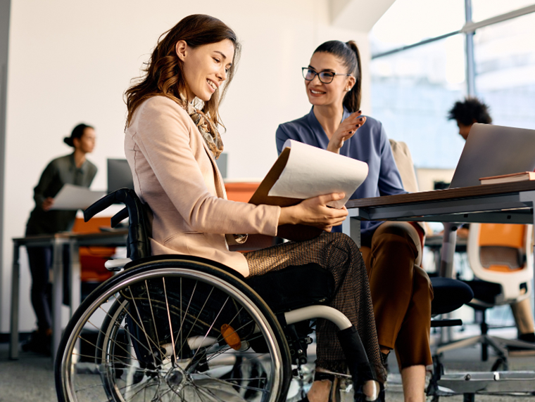 Woman in wheelchair coaching someone 